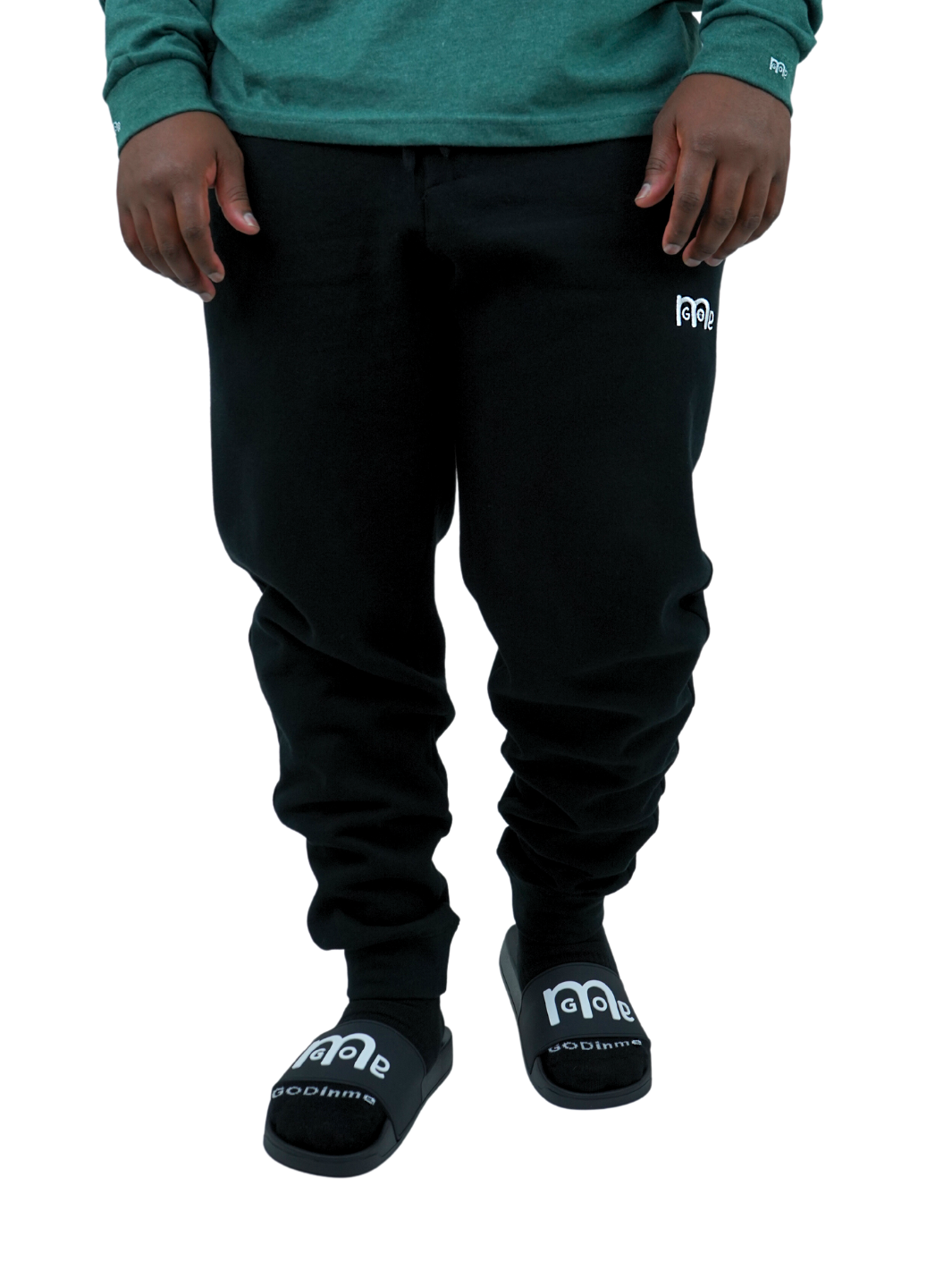 Experience the ultimate comfort in Men's joggers with GODinme! Made with premium quality fabric, these Black GODinme sweat pants offer an elastic waistband for that perfectly relaxed fit. Featuring ribbing ankle cuffs, sewn eyelets, and the signature GODinme logo (in White) at left leg.