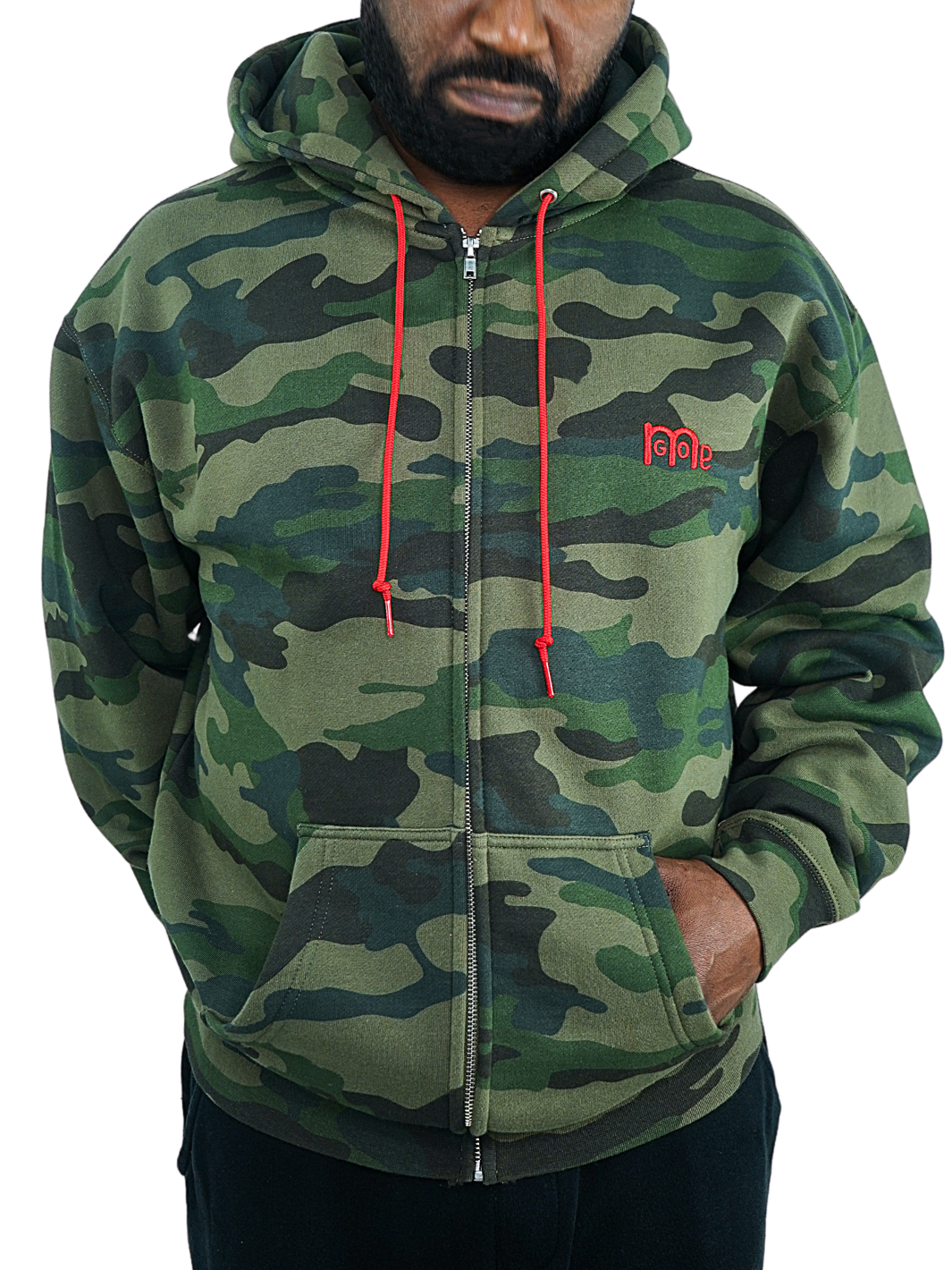 Green Camouflage Full Zip Hoodie with Red drawcord, embroidered GODinme logo at left chest and ROMANS 12 : 21 on hood. Both embroideries are in Red. 