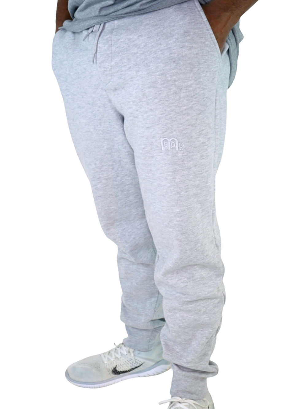 Experience the ultimate comfort in Men's joggers with GODinme! Made with premium quality fabric, these Grey GODinme sweat pants offer an elastic waistband for that perfectly relaxed fit. Featuring ribbing ankle cuffs, sewn eyelets, and the signature GODinme logo (in Grey) at left leg.