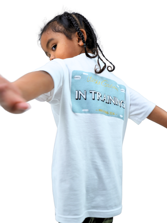 White T-shirt with "In Training" and Proverbs 22:6 printed within license plate design on back and woven GODinme tag attached to bottom front 