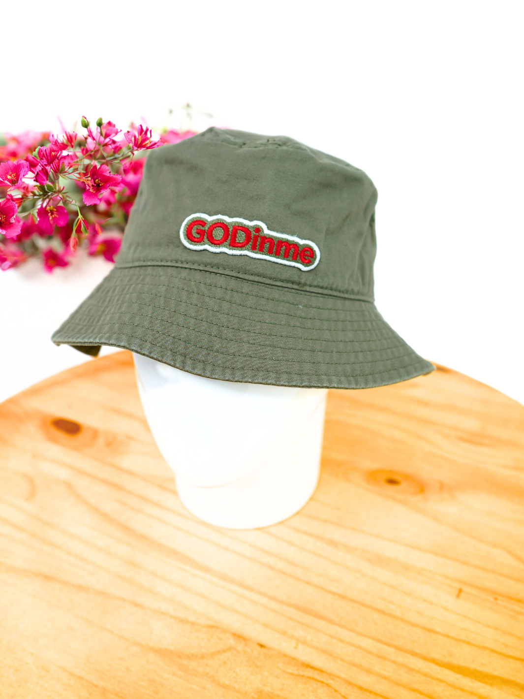 Represent your timeless style with this Olive Green GODinme Bucket Hat featuring GODinme brand name and logo embroidered in Red.