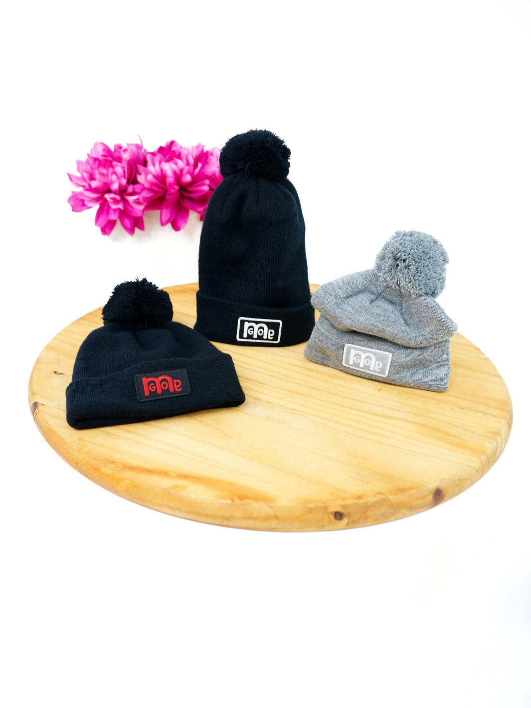 Black or Grey Super soft silk like acrylic Pom Pom Beenies with iconic GODinme patch logo in White or Red adding the perfect unique representation of GOD: in you.