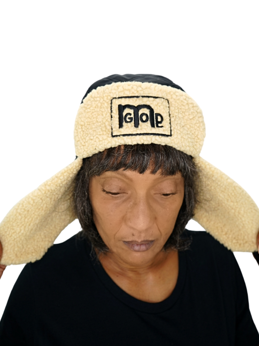 3 Panel Trapper Hat with Beige Sherpa lining and Black double stitch quilted diamond shape outer shell to provide ultimate quality with softness. Adjustable chin strap is embroidered with GODinme and the front panel has the GODinme logo.