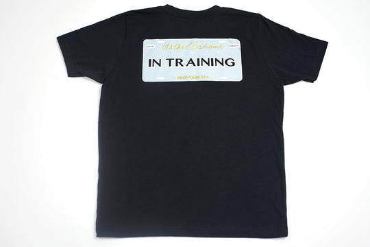Black T-shirt with "In Training" and Proverbs 22:6 printed within license plate design on back and woven GODinme tag attached to bottom front 