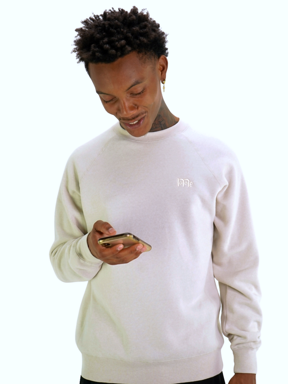 Model wearing a GODinme Creme Crewneck Sweater with raglan sleeves and embroidered GODinme logo at left chest.