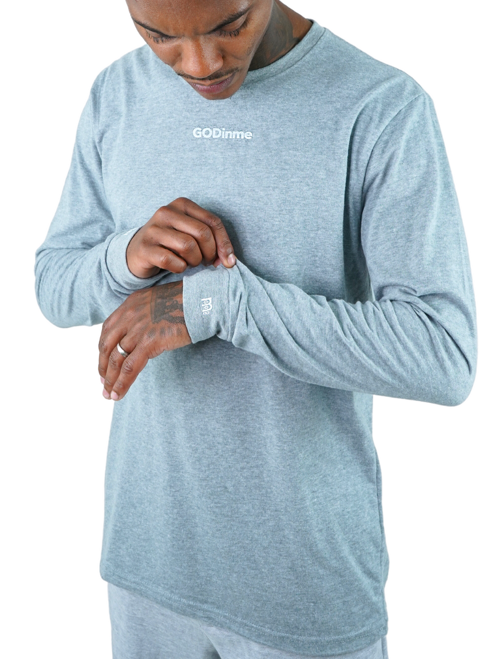 Made to feel like sueded peach fuzz, this Grey long sleeve shirt offers unbeatable comfort. The GODinme printed on front chest and the logo on sleeve cuffs and upper back represent boldness and style.