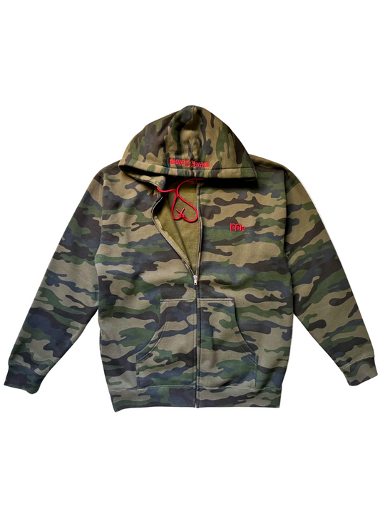 Flat lay of a Green Camouflage Zip Up Hoodie with Red drawcords, embroidered Red GODinme logo at left chest, and embroidered Red ROMANS 12 : 21 on hood. 