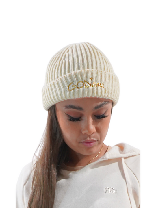 Christian model wearing a beige fisherman's beanie with gold GODinme embroidered on fold.
