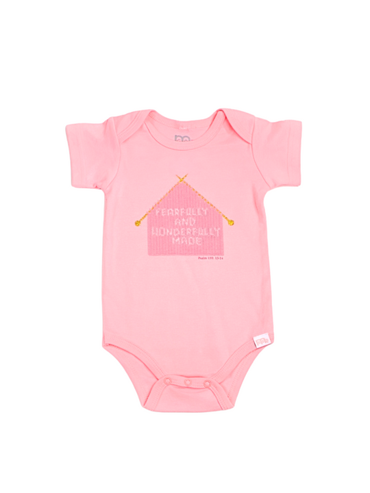 Pink Infant Onesie with "Fearfully and Wonderfully Made" printed on front and woven tag GODinme logo at left leg.