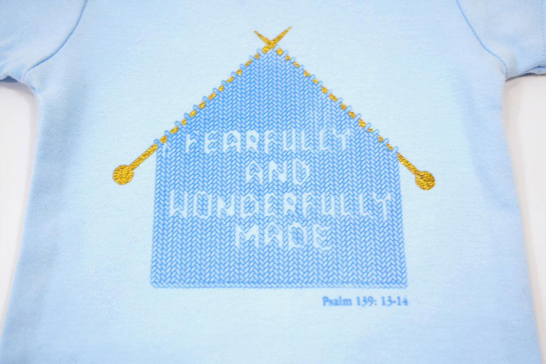 Blue Infant Onesie with "Fearfully and Wonderfully Made" printed on front and woven tag GODinme logo at left leg.